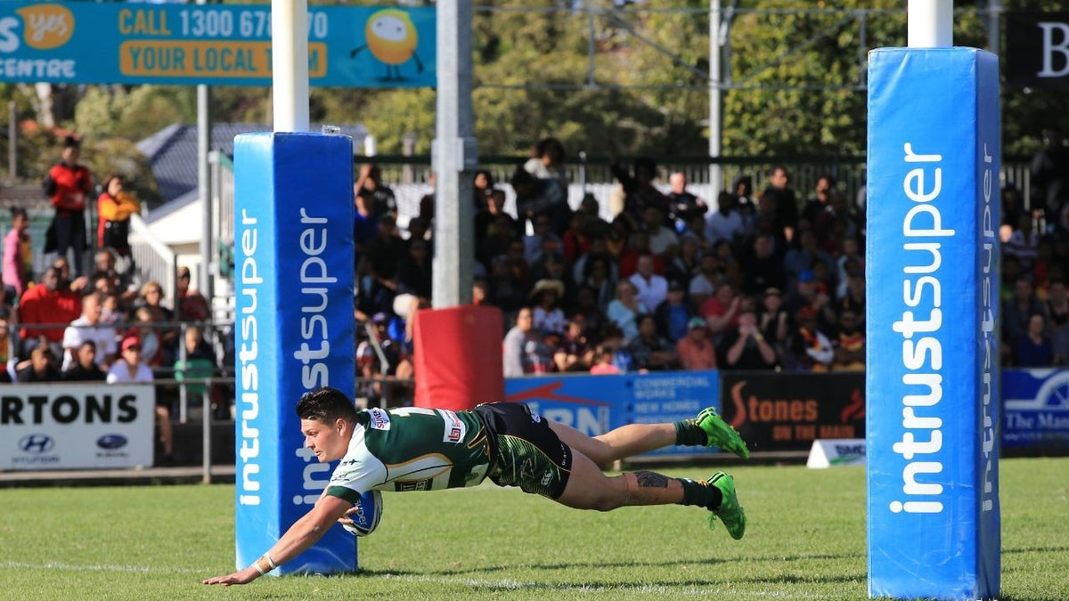 Blue Intrust Super rugby goal post pads installed on the field during a match.