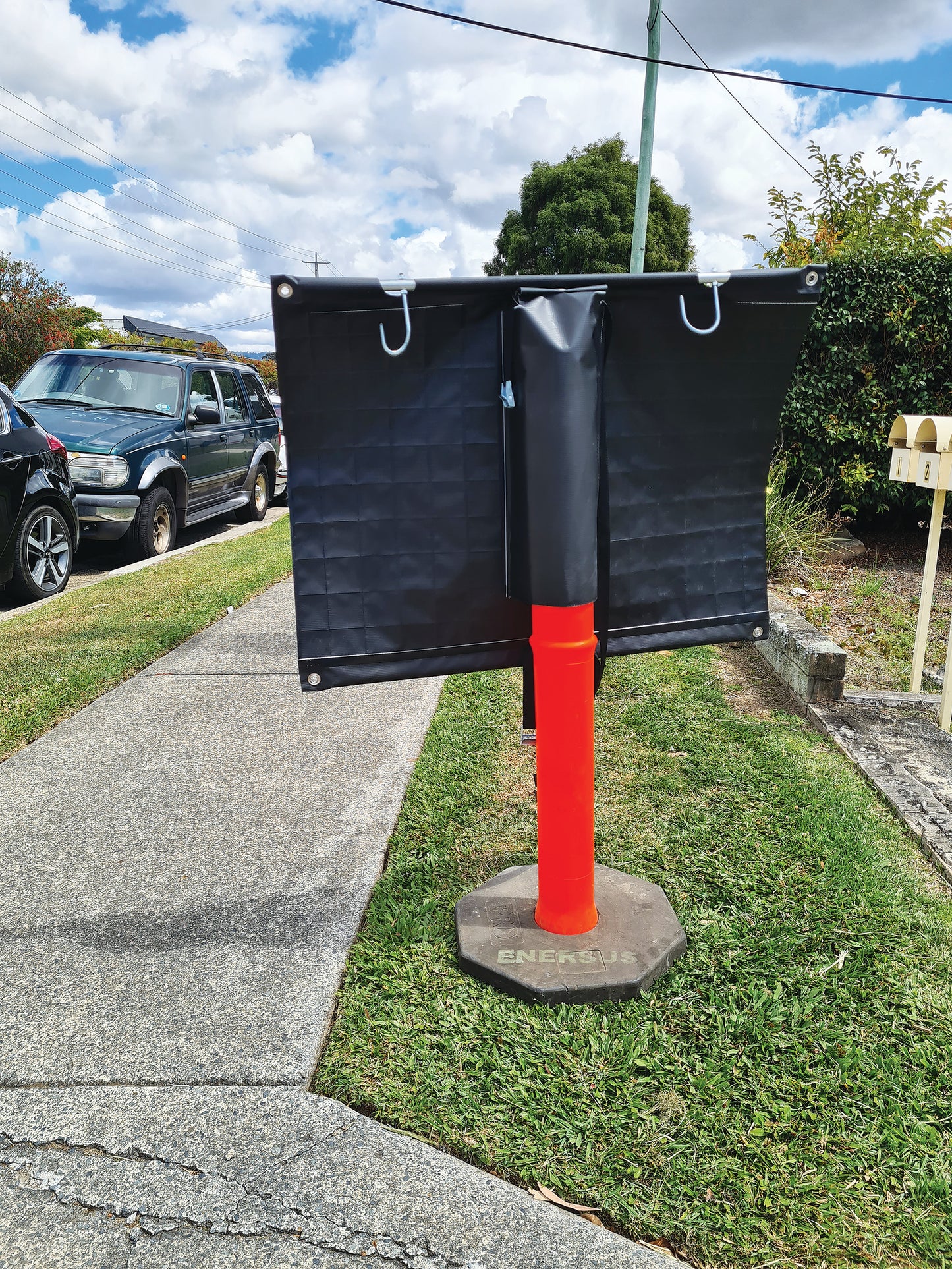 Multi Fit Roll Up Sign Mounted on a safety cone to display portability and finished with eyelets, stiffening rods and hooks.