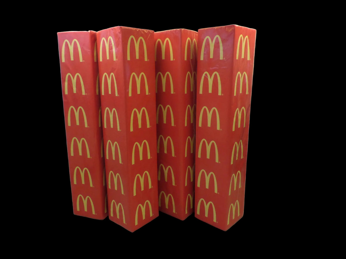 Four red rugby goal post pads with yellow McDonald's sponsor logos.