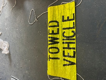 HVSOTV reflective roll up banner folded to display TOWED VEHICLE message