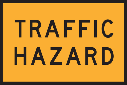 Traffic hazard warning sign with black text on a yellow background